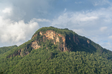Landscape view of limestone mountain with cliff  emerging from tropical forest in the beautiful...