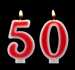 Red birthday candles isolated on black background, number 50