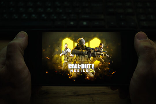 Kostanay, Kazakhstan, November 04, 2021.A man holds a mobile phone with a screensaver of the popular Call of Duty game.