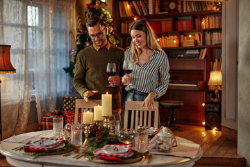 Beautiful young couple is celebrating Christmas at home.