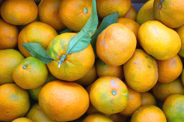 Wooden crate filled with fresh tangerines. Top view.