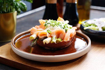 Sandwich with smoked salmon and asparagus, served with a green salad.
A tasty dish.Culinary photography. Suggestion to serve the dish.