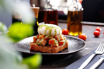 Bruschetta with burrata and basil pesto.
Appetizing dish. Culinary photography, a proposal to serve a meal.