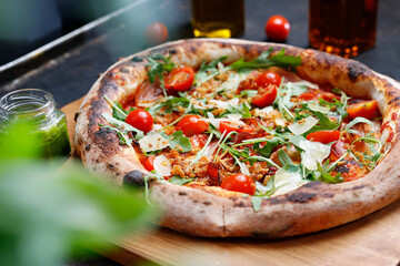Pizza with tomatoes and arugula.
Proposal for dishes..Culinary photography. Suggestion to serve the dish.