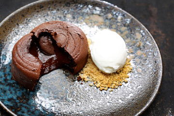 Chocolate cake with ice cream and nuts. Tasty sweet dessert. A tasty dish.Culinary photography. Suggestion to serve the dish.