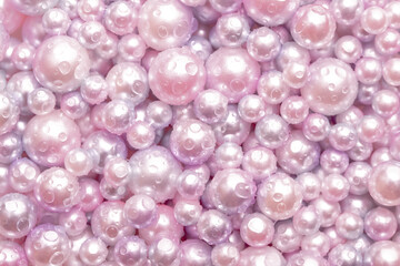 Beautiful background pink pearl pearls, top view. Abstract texture for festive backgrounds. Shiny...
