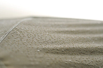 Raindrops on the awning of the tent. Rainy day in the mountains.