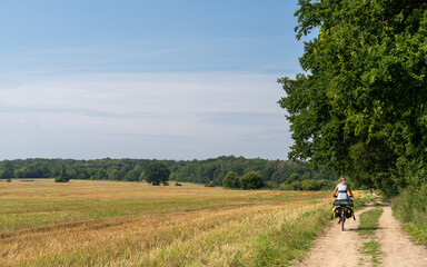 Person riding a bicycle in the field, Schorssow, Germany