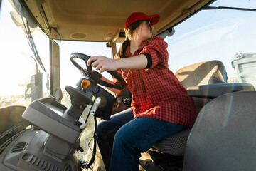 Young  woman drives tractor in field © Dusan Kostic