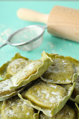Concept of cooking ravioli on mint background