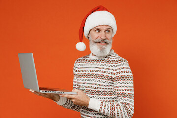 Old fancy vivid charismatic smiling fun bearded Santa Claus man 50s wear Christmas hat sweater...