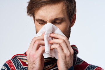 sick man with a handkerchief health problem flu symptoms light background - obrazy, fototapety, plakaty