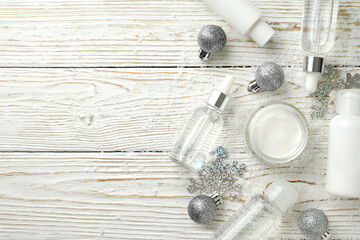 Composition with winter cosmetic products on white wooden table