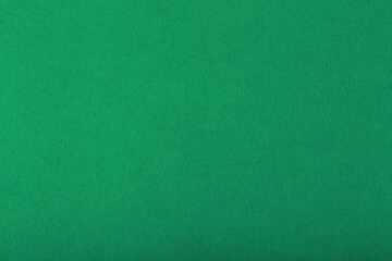 Green fluffy felt fabric close up. Abstract cozy background with space for text. Template concept