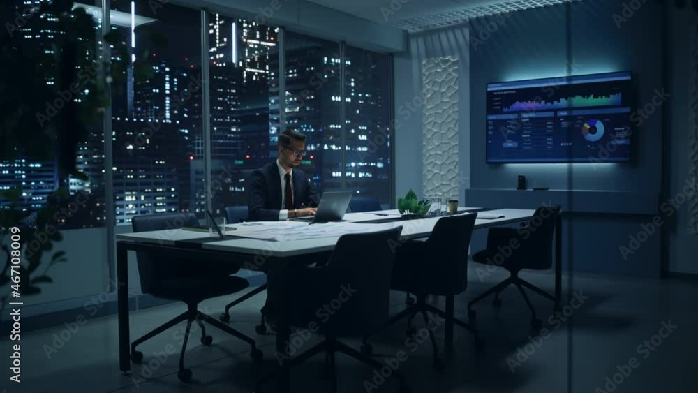 Aufkleber successful handsome businessman working on laptop computer in big city office late in the evening. f