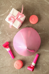 Birthday accessories on gray textured background, top view