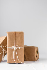 Gifts wrapped in plain brown paper and twine, gifts in brown kraft paper