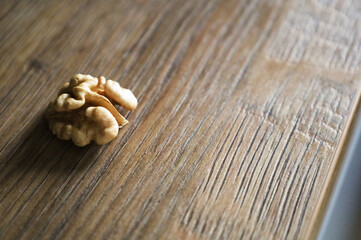 Peeled walnut.lies on a table with a wooden structure