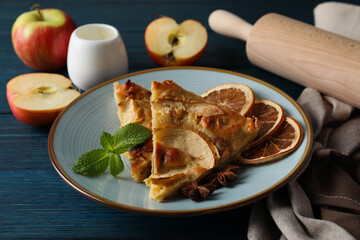 Concept of tasty food with apple pie on wooden background