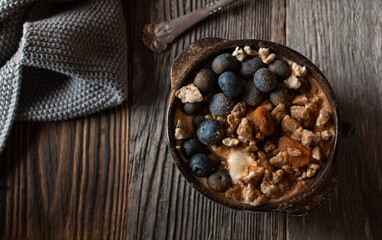 Fitness breakfast bowl with greek yogurt, pureed pumpkin, smashed brown rice cracker, blueberries and cinnamon