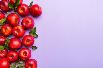 Many red apples on colored background, top view. Autumn pattern with fresh apple above view with copy space for design or text