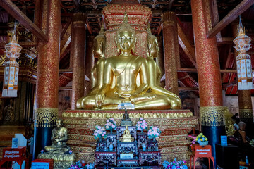Wat Pra Tard Chang Kum Buddhist temple locate on Amphoe Mueang Nan District, Thailand with background of cloudy sky.