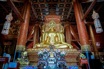 Wat Pra Tard Chang Kum Buddhist temple locate on Amphoe Mueang Nan District, Thailand with background of cloudy sky.