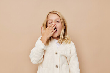 emotional girl gestures with his hands on a beige background