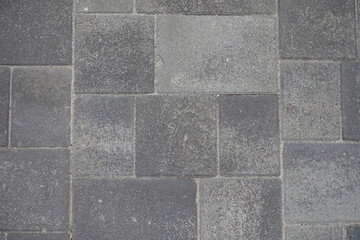 Background - pavement made of rectangular gray concrete blocks