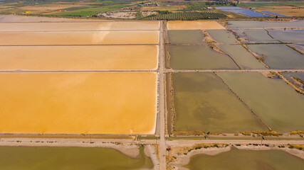 Aerial view of yellow colored salt pans at West Greece