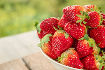 freshly picked organic strawberry on wooden table natural background, countryside, healthy eating. 