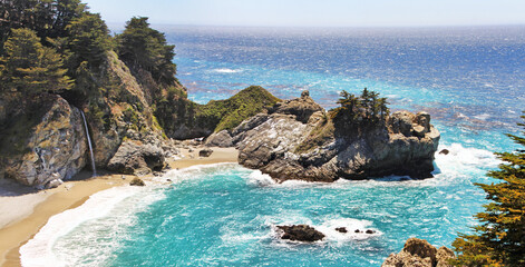 A beautiful waterfall falls to the beach in California.