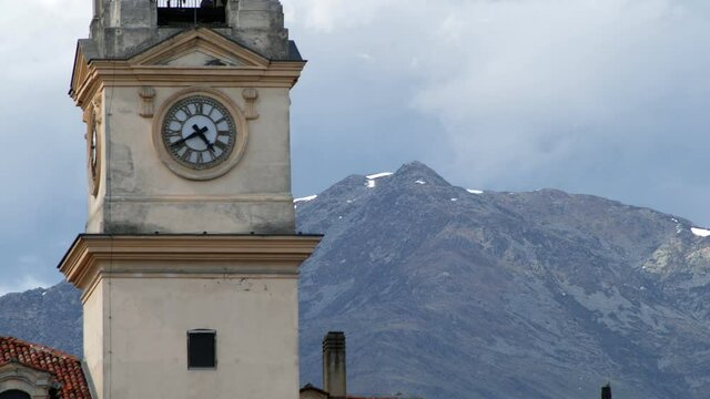 Detail of the ancient church in Ivrea with the mountains background. Italy. Video 4K