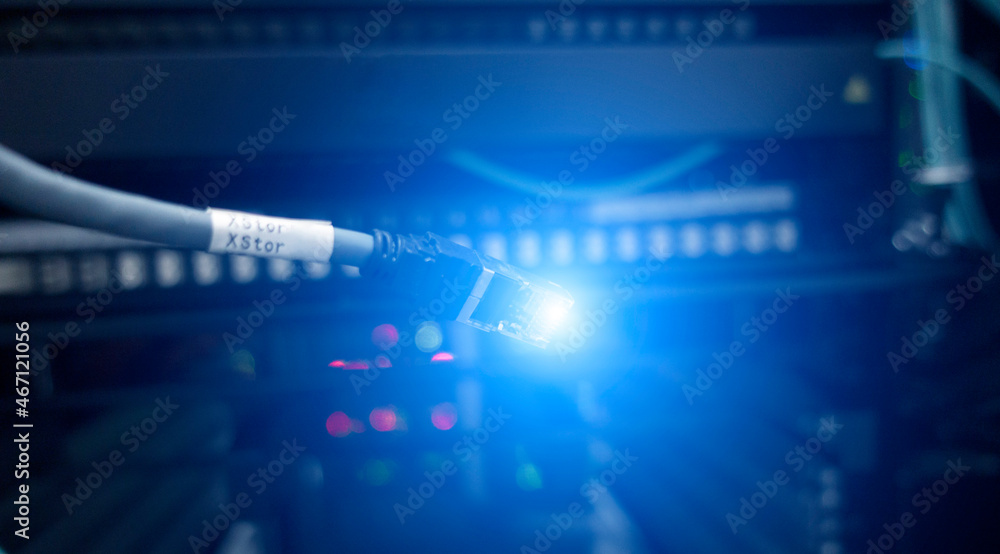 Poster network connection, closeup view of curved ethernet cable plug connector rg-45 on server background.
