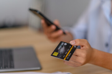 female employee holding credit card in office