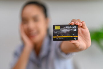 female employee holding credit card in office