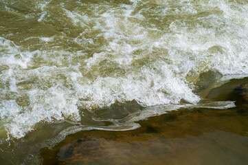 Fast flowing cold water mountain stream, nature outdoors, fresh stream dark blue water
