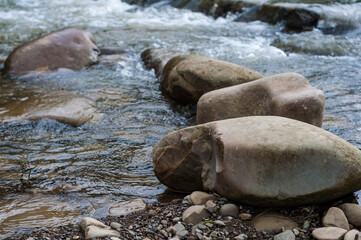 Close-up large smooth stones near stream mountain stream, a stream clear crystal clear water