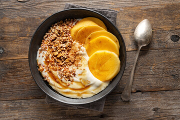 Tasty bowl with yogurt and persimmon