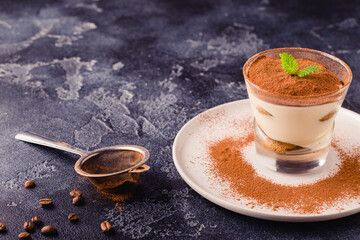 Traditional Italian dessert tiramisu in a glass.
