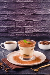 Traditional Italian dessert tiramisu in a glass.