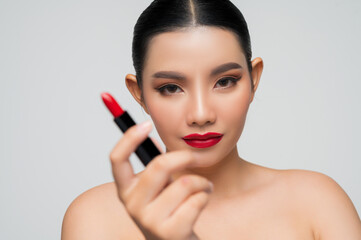 Portrait of Beautiful Asian woman with lipstick in hand