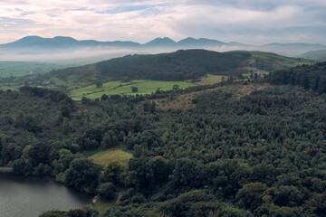 Naklejka premium aerial view Castlewellan forest park during foggy summer morning, Northern Ireland
