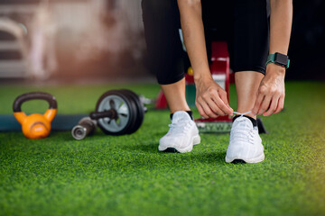 Fototapeta premium Close up of Fitness athlete's foot, Healthy lifestyle, and sport concepts. Woman in fashionable sportswear is doing exercise.