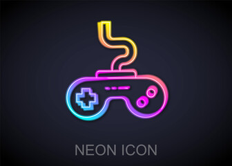 Glowing neon line Gamepad icon isolated on black background. Game controller. Vector