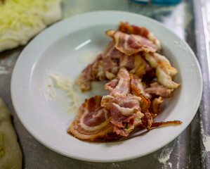 cooked bacon to decorate a pizza