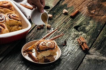 Baked sweet cinnamon rolls on a wooden table. Sinnabon buns rolls. swedish dessert