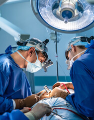 Neurosurgeon is operating with medical robotic surgery machine. Manual control by minimally...