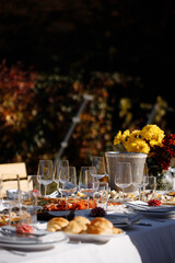 Cocktail champagne, table with champagne and glass glasses. In the background are fruits and food.