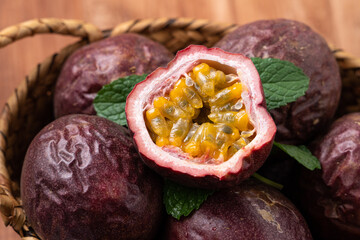 Delicious juicy passion fruit on wooden table background.